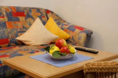 a bowl of fruit on a table next to a couch at Haus Bernhard in Schenna