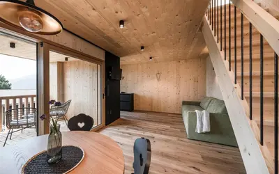 a small house with a staircase and a table at Stadl Chalet oberhalb Brixen in Rosa