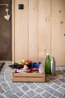 a table with a tray of food and a plate of food at Stadl Chalet oberhalb Brixen in Rosa