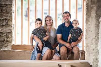 a family posing for a picture on a porch at Stadl Chalet oberhalb Brixen in Rosa