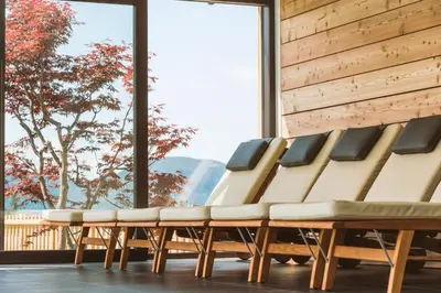 a row of chairs in a room with a large window at Hotel Regina in Soprabolzano
