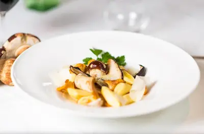 a white plate of food on a table at Hotel Regina in Soprabolzano