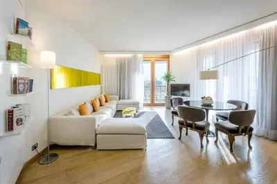 a living room with a white couch and a table at Hotel Therme Meran - Terme Merano in Merano