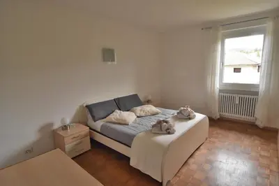a bedroom with a bed with two stuffed animals on it at Appartamento Da Romina con parcheggio gratuito in Sanzeno