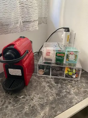a red toaster sitting on a counter next to a drawer at Franz home Wi-Fi AC 1 free parking in Bolzano