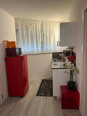 a kitchen with a red refrigerator in a room at Franz home Wi-Fi AC 1 free parking in Bolzano
