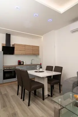 a kitchen and living room with a table and chairs at Imperial Deluxe in Merano