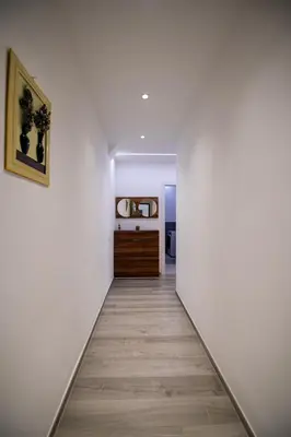 a hallway with white walls and a wooden floor at Imperial Deluxe in Merano