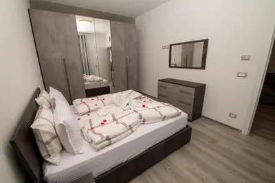 a bedroom with a large bed and a mirror at Imperial Deluxe in Merano
