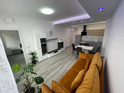 a living room with a couch and a kitchen at Imperial Deluxe in Merano