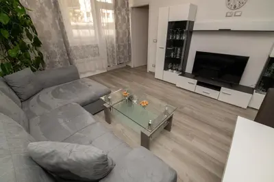 a living room with a couch and a television at Imperial Deluxe in Merano
