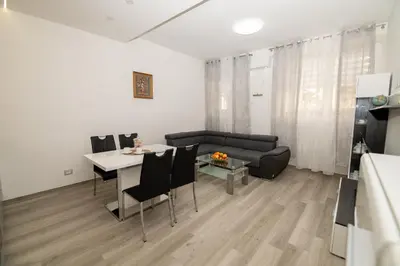 a living room with a table and a couch at Junior Deluxe 2 in Merano