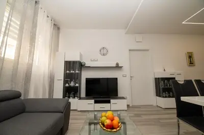 a living room with a couch and a television at Junior Deluxe 2 in Merano