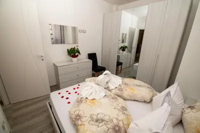 a bedroom with a bed with pillows and a mirror at Junior Deluxe 3 in Merano