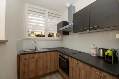 a kitchen with wooden cabinets and a sink and a window at Junior Deluxe 3 in Merano