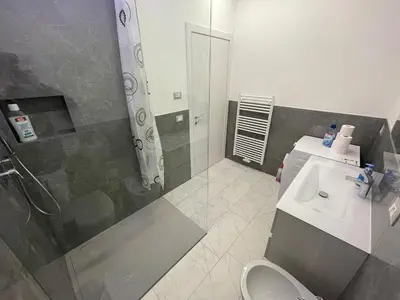 a bathroom with a shower and a toilet and a sink at Junior Deluxe 3 in Merano