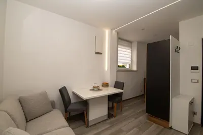 a living room with a table and a couch at Junior Deluxe 3 in Merano