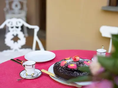 a table with a chocolate doughnut on a pink table at Villa Atelier Baron Killi in Caldaro