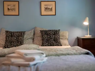 a bedroom with a bed with a blanket and pillows at Villa Atelier Baron Killi in Caldaro