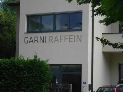 a building with a sign that reads camp rutherford at Garni Raffein in Lana