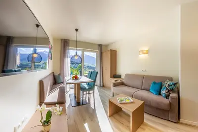 a living room with a couch and a table at Apartments Lichtenberg in Lagundo