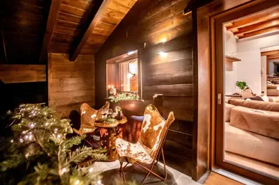 a room with a table and chairs and a bedroom at iFlat Chalet Carole Ortisei in Ortisei