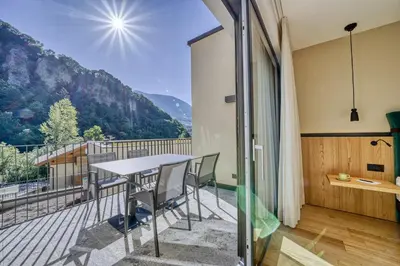 a balcony of a house with a table and chairs at Castanea Appartements in Caines
