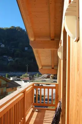 a wooden balcony with a view of a building at LA CIESA DEI SIORI in Alleghe