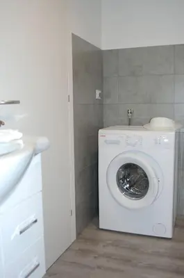 a washing machine in a bathroom with a sink at LA CIESA DEI SIORI in Alleghe