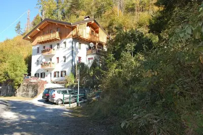 a house with a car parked in front of it at LA CIESA DEI SIORI in Alleghe