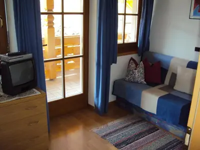 a room with a bed and a tv and a window at Gandlerhof in Valdaora