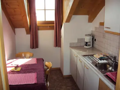 a small kitchen with a table and a sink at Gandlerhof in Valdaora
