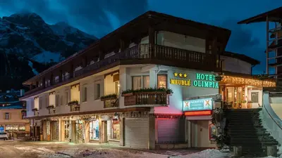 a building with a sign that reads house motel cuillin at Hotel Olimpia in Cortina dʼAmpezzo