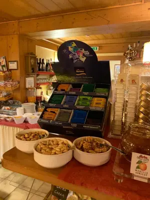 a counter with several bowls of food on a table at Meuble Villa Neve in Cortina dʼAmpezzo