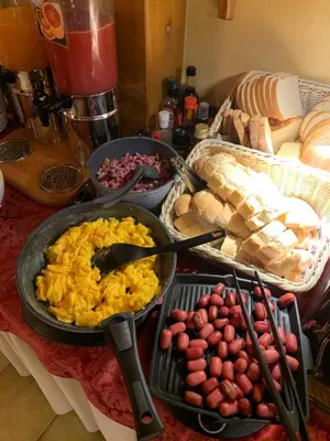 a table with plates of eggs and other food at Meuble Villa Neve in Cortina dʼAmpezzo