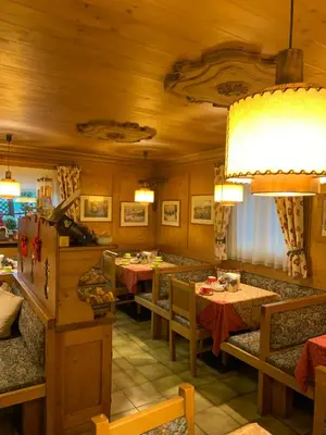 a restaurant with tables and chairs in a room at Meuble Villa Neve in Cortina dʼAmpezzo