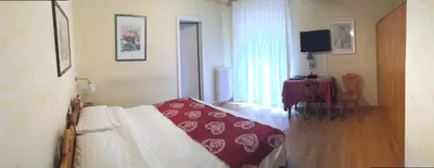 a room with a couch and a table and a window at Meuble Villa Neve in Cortina dʼAmpezzo