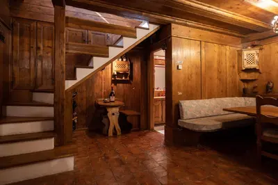 a room with a staircase and a sink in a house at Casa Regoiettes in San Vito di Cadore