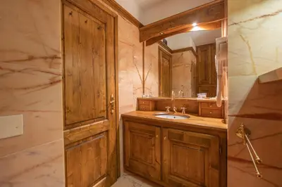 a bathroom with a sink and a mirror at Casa Regoiettes in San Vito di Cadore