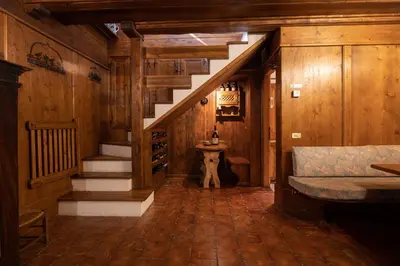 a hallway of a house with a staircase and a sink at Casa Regoiettes in San Vito di Cadore