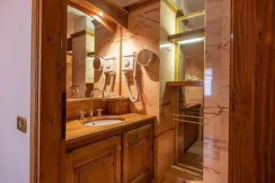 a bathroom with a sink and a shower at Casa Regoiettes in San Vito di Cadore