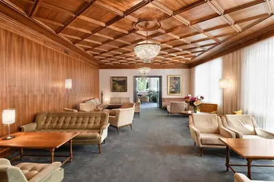 a waiting room with couches and chairs and tables at Hotel Juliane in Merano