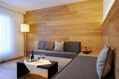 a living room with a couch and a table at Bio & Wellnesshotel Pazeider - Healing Garden above Meran in Marlengo