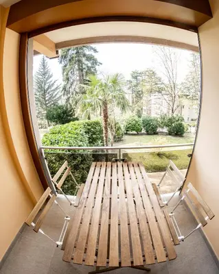 a room with a bench and a large window at Flow Apartments Astoria in Merano