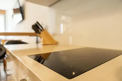 a kitchen counter with a black counter top at Flow Apartments Astoria in Merano