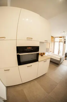a kitchen with white cabinets and a microwave at Flow Apartments Astoria in Merano