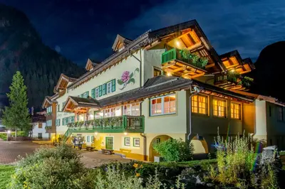 a hotel in the mountains at night at Hotel Villa Rosella Park & Wellness in Canazei