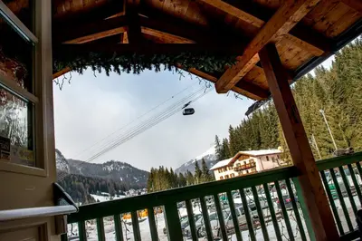 a view from a balcony of a ski resort at Hotel Villa Rosella Park & Wellness in Canazei