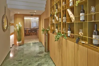 a room with a bunch of bottles of wine on shelves at Hotel Post Gries in Bolzano