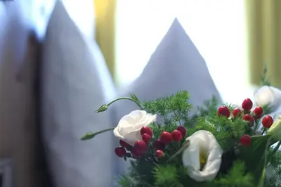 a vase filled with flowers and decorations with surfboards at Hotel Post Gries in Bolzano